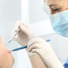 Dentist checking the patient with Mouth mirror