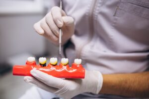 Female patient receiving Zirconia implants from dentist in modern dental clinic