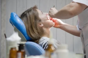 Dentist performing dental checkup on girl for wisdom teeth in Sydney