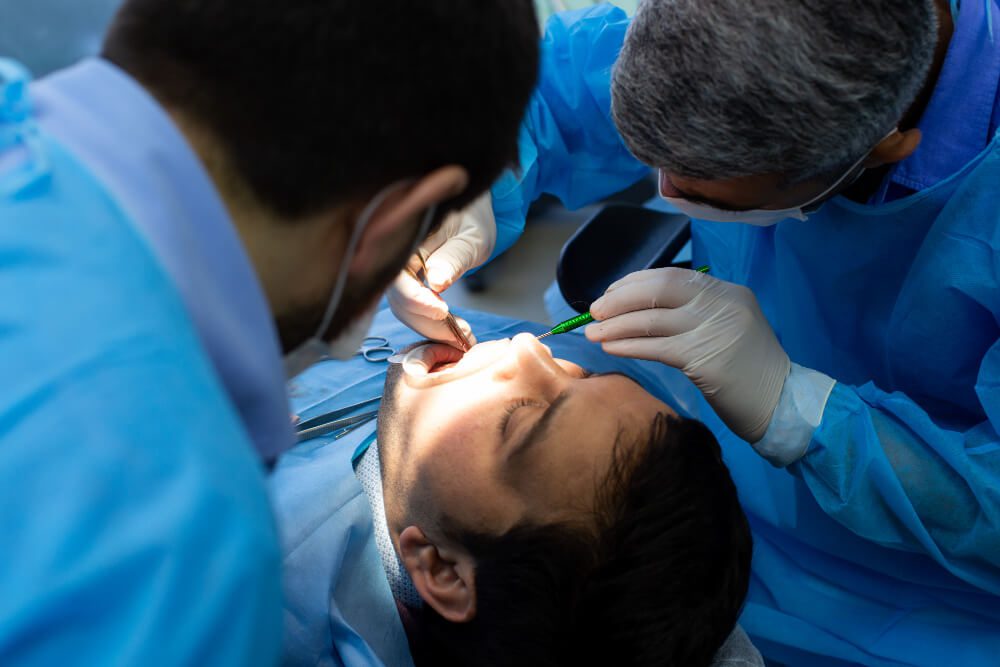 Dentist performing wisdom teeth extraction on patient