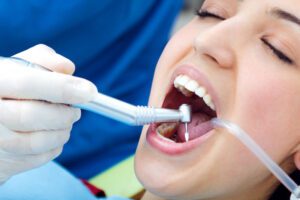 woman undergoing wisdom teeth extraction at dental clinic