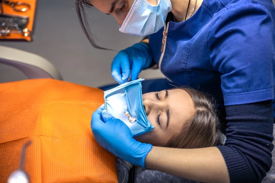 Dentist prepares a patient for wisdom teeth removal under local anaesthetic at Pinho Dental in Sydney. 